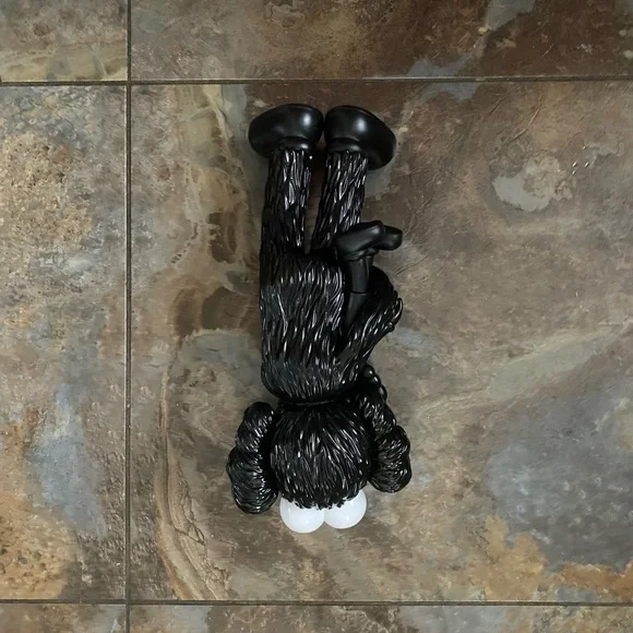 BFF KAWS carrying a Black Kaws Baby Figure